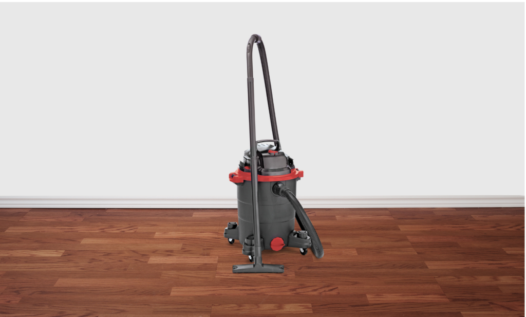 Shop-Vac WARN case settlement. View of a Shop-Vac barrel style heavy duty vacuum in an empty room.