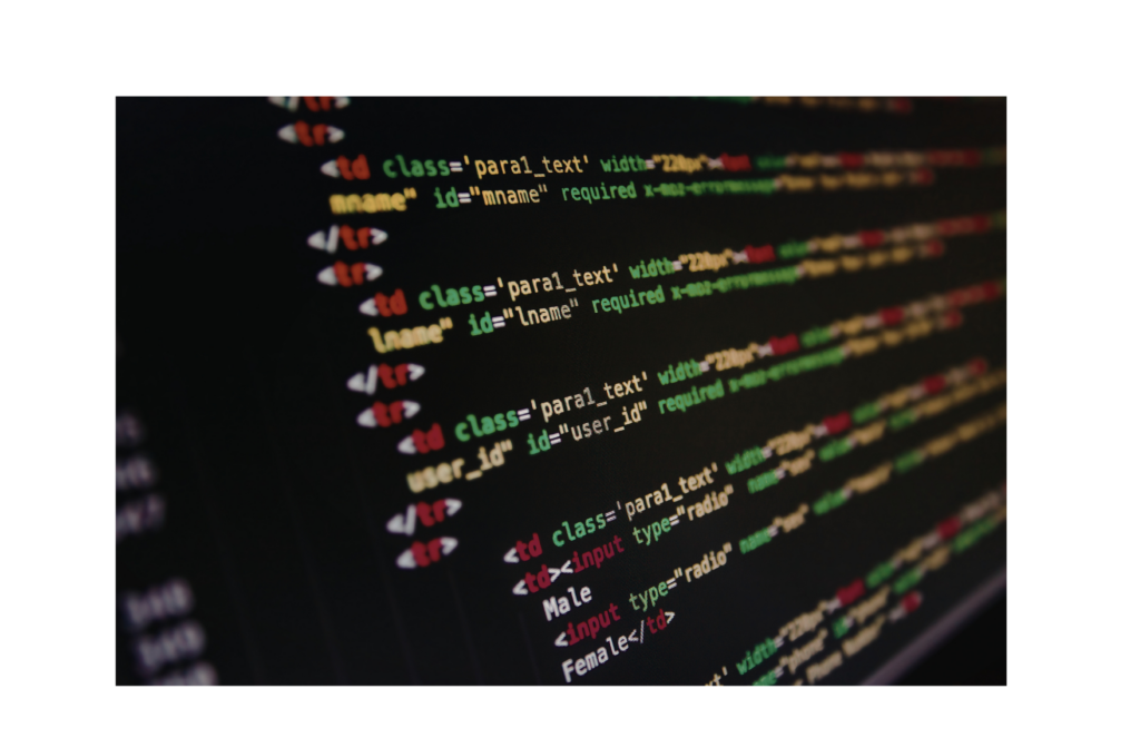 Picture of software coding in several colors on a black computer screen.