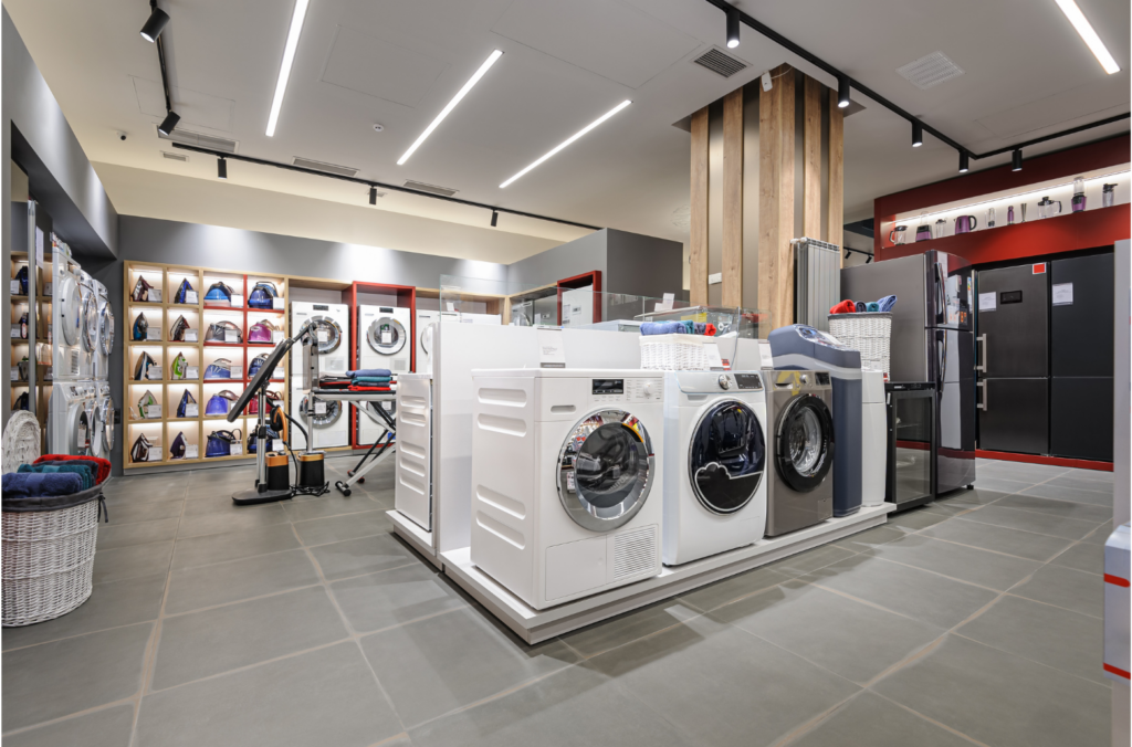 Polished WARN class action. View of washing machines, irons, and other small appliances in an appliance store.