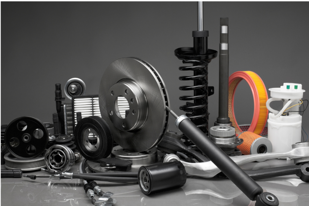First Brands Group and Brake Parts Inc layoff. Close up view of different auto parts: air filters, shocks, etc.