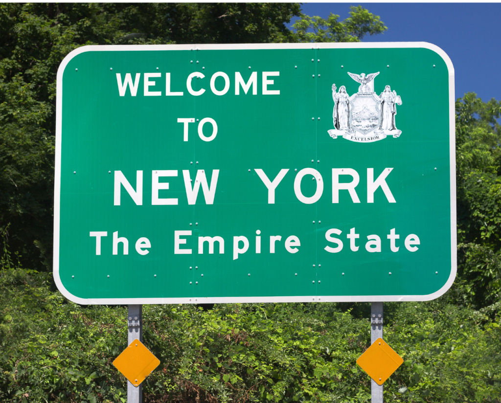 New York WARN Act, view of street sign, the sign reads: Welcome to New York, The Empire State, and shows the state crest which includes the word Excelsior at the bottom.