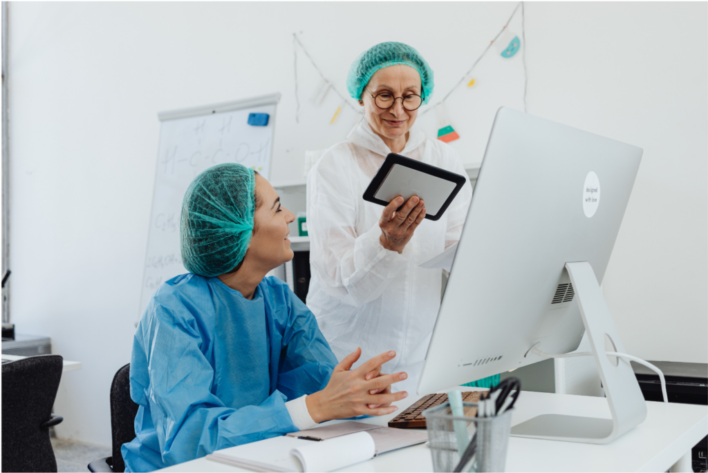 The court granted approval. Interactive Health. Two female medical professionals review results on a computer and tablet.