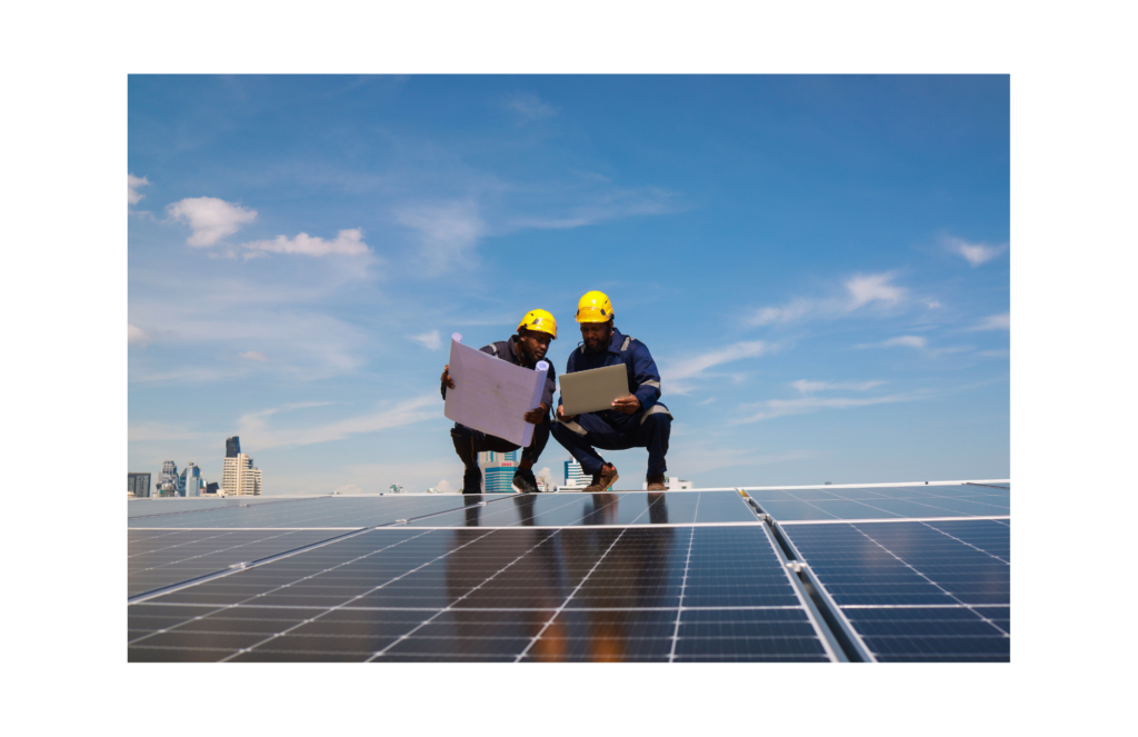 Allstate Sales Group layoff. View of two workers standing by a large solar panel. Both holding blueprints.