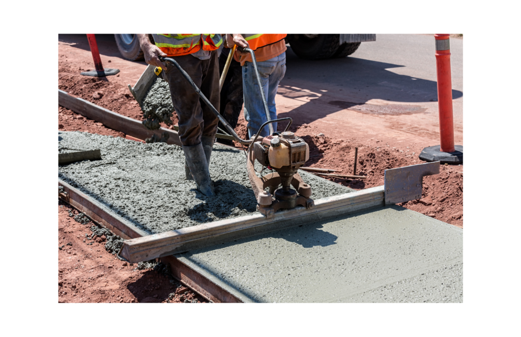 Tendit WARN class action. Worker using equipment to smooth out new concrete sidewalk.