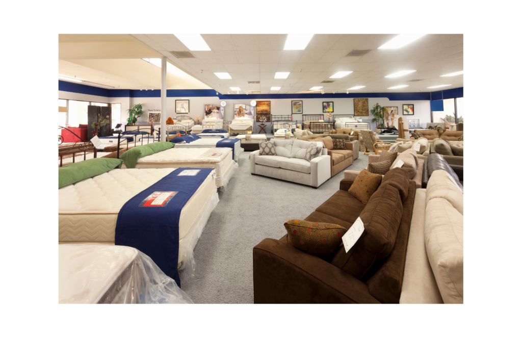 Art Van WARN case. View of a small town furniture store showroom. Several mattresses and bed frames on the left with many types and styles of couches on the left.