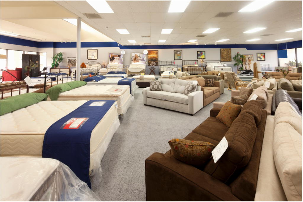 Art Van WARN case. View of a small town furniture store showroom. Several mattresses and bed frames on the left with many types and styles of couches on the left.