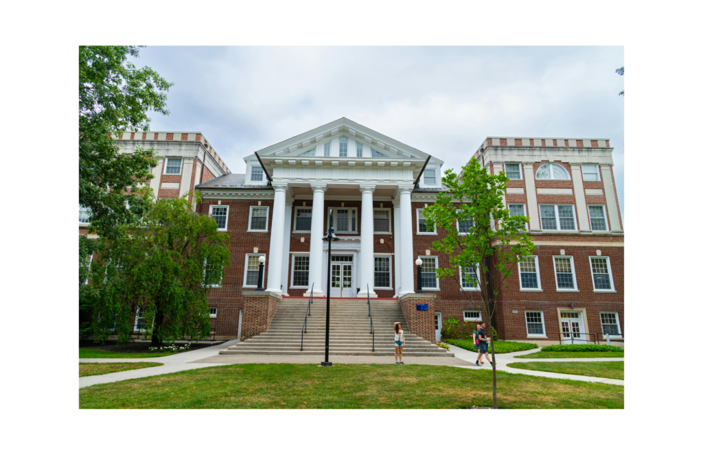 Dowling College WARN case. View of a red brick building with large white pillars on a college campus. This building has a large lawn with multiple sidewalks in front of it.