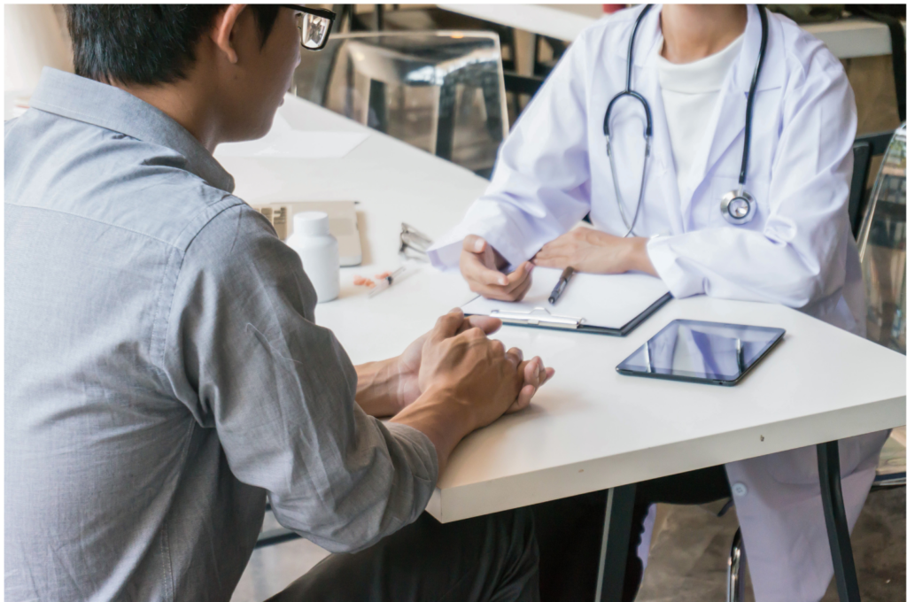 Optum WARN case. View of a medical professional interviewing a patient, with a tablet, clipboard, and pen present.