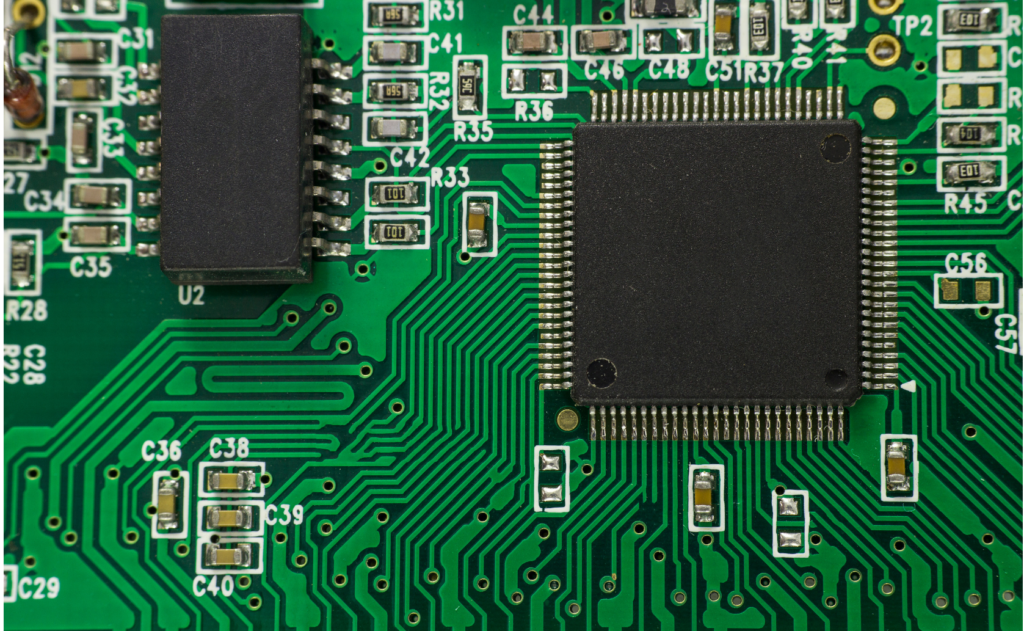 Qimonda WARN class action. Close up view of a computer chip. Numbers, soldering, and wiring shown in detail.