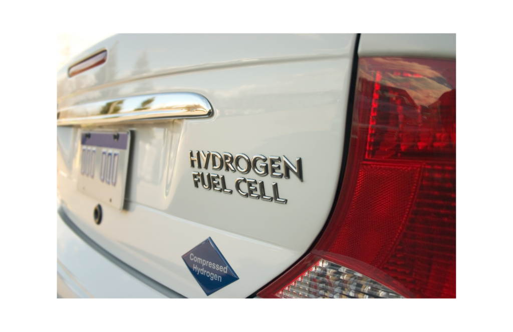 ClearEdge Power WARN class action. View of car's rear left trunk with the words Hydrogen Fuel Cell in silver raised letter. Below those words is a diamond blue logo reading Compressed Hydrogen.