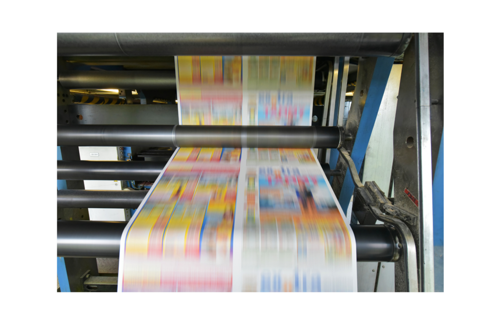 Colortree WARN class action. View of a high speed printing press with colorful printing shown on a long piece of paper as it moves through the rollers on the machine.