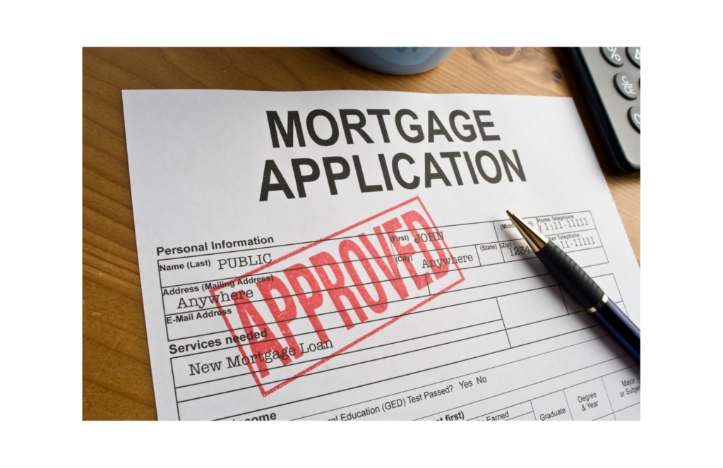 Ideal Mortgage/Lend American WARN class action. View of a completed mortgage application on a table with the word APPROVED stamped in red on it. On top of the application is a pen. Beside the pen there is a partial view of left side of a desk calculator.