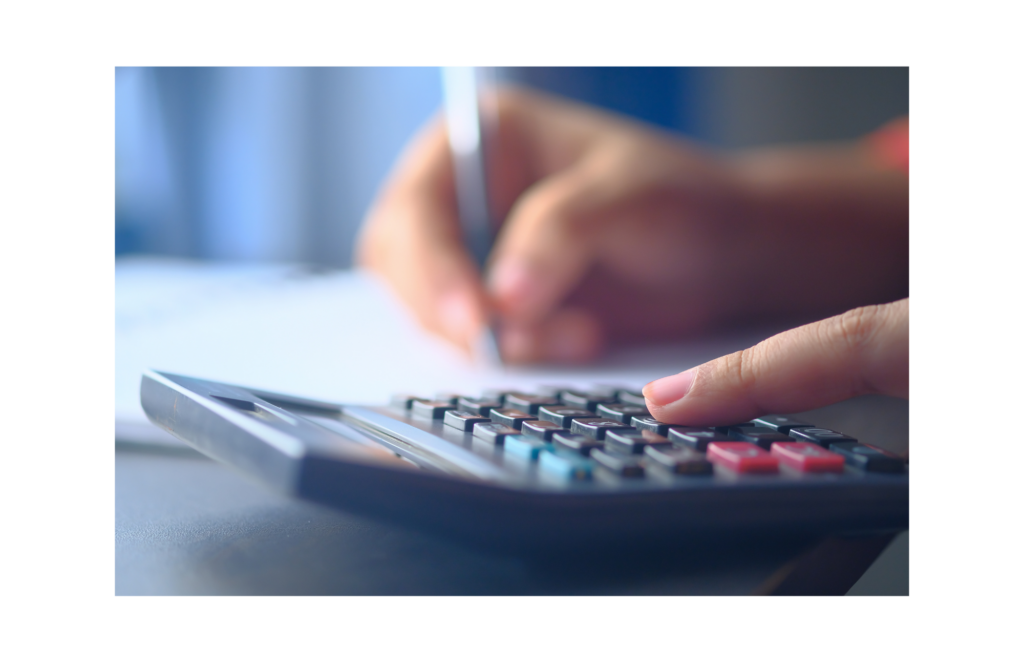 Strategic Financial WARN class action. Close up view, left hand on a calculator, blurry in the background is a hand holding a pen.